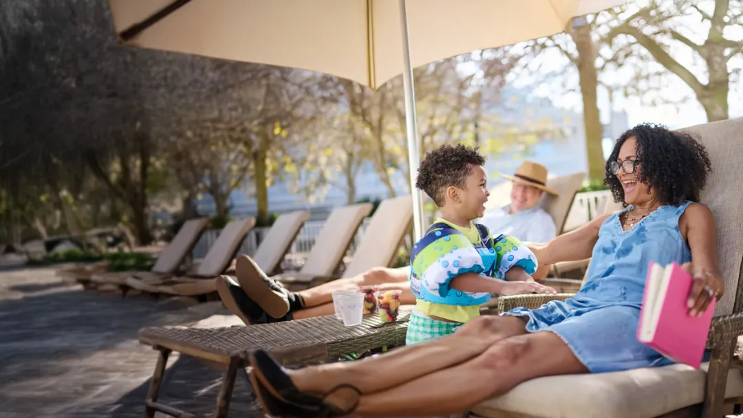 A Little Boy Talks to His Grandmother by the Pool.