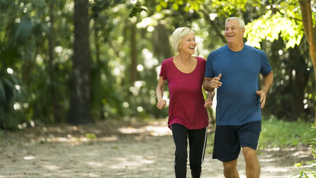 Older couple Jogging through the woods