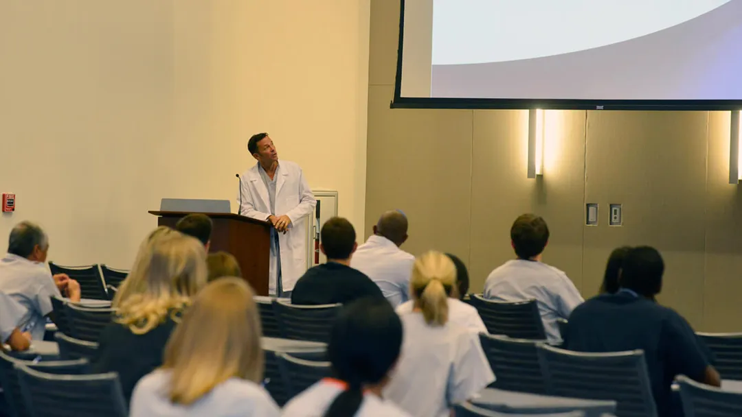 Man speaking at a conference.