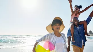 A healthy family enjoys a summer day on the beach.