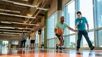 Man doing basketball drills with trainer