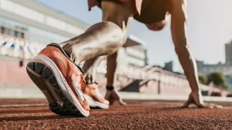 A low-angle shot of a male runner about to start a race