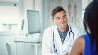 Doctor sitting at a table with a patient