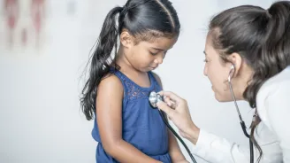 Little girl at doctor stethoscope