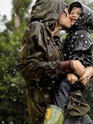 Mom and little boy playing in the rain.