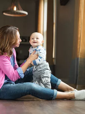 Baby standing with Mama.