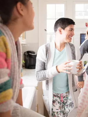Family dancing in kitchen during breakfast.