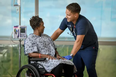 A female patient in a wheelchair with her provider.