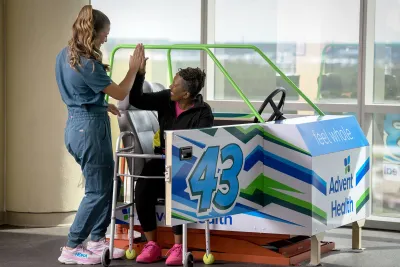 A female patient hi-fiving her healthcare provider