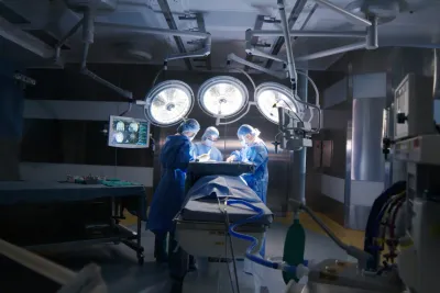 Three Doctors Work on a Patient in an Operating Room