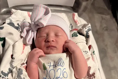 Baby Eliza arrived at 12:21 a.m. Jan. 1, 2026. She is seen in a baby outfit atop a blanket.