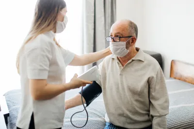 A man getting his blood pressure checked at the doctor. 