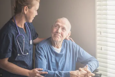 Nurse with a male hospice patient.