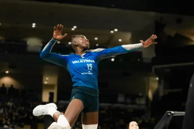 Orlando Valkyries player jumps into the air to hit a ball