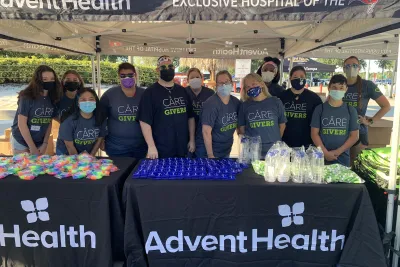 A group of masked volunteers posing for a photo