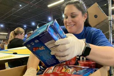 A woman holding boxes of food