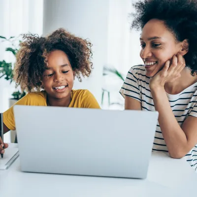A Mother and Daughter Surf the Internet on a Laptop in Their Home.