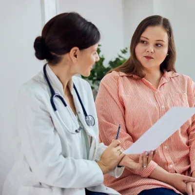 A Doctor Goes Over a Chart with a Patient