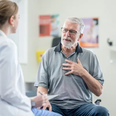 A Senior Patient Speaks to His Physician is an Exam Room