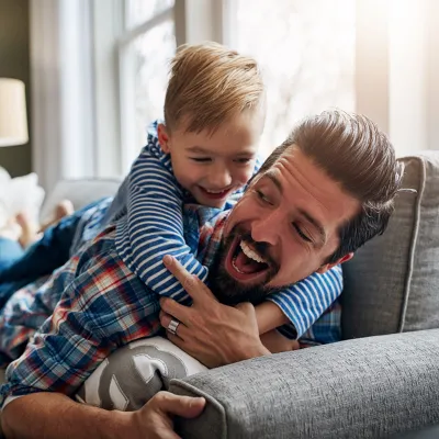 Son Hugging Father on Couch