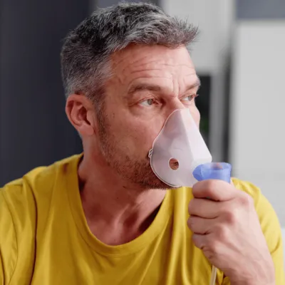 A Man Doing a Breathing Test in a Doctor's Office
