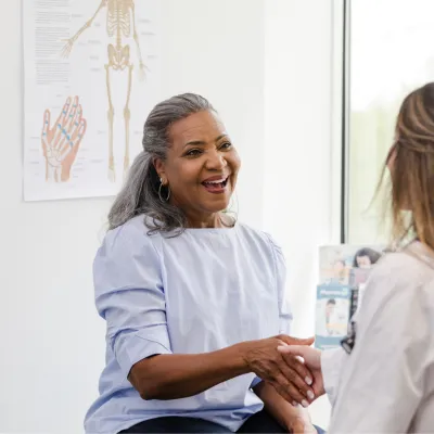 A Patient Greets a Provider in an Exam Room
