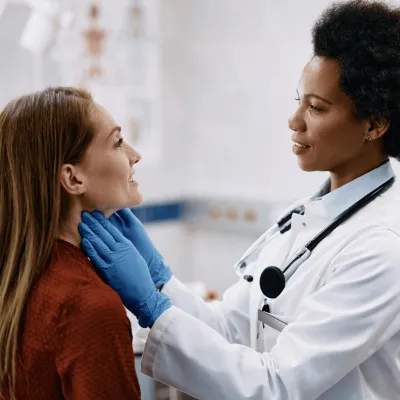 A Physician Checks Her Patient's Throat in a Practice Office.