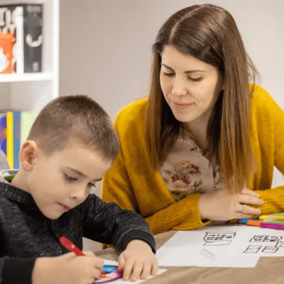 A Mother Helps Her Child with His Homework