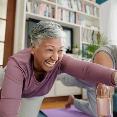 Senior Woman and Man doing pilates together at home.