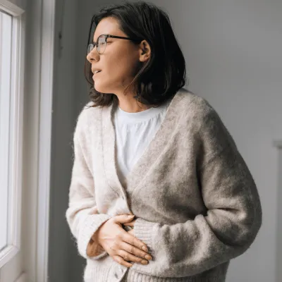 Woman grabbing stomach 