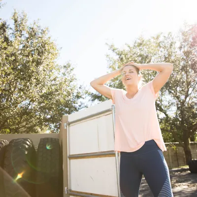 Woman Relaxing with Tires in Background 