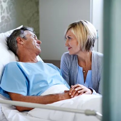 Woman visiting husband in the hospital.