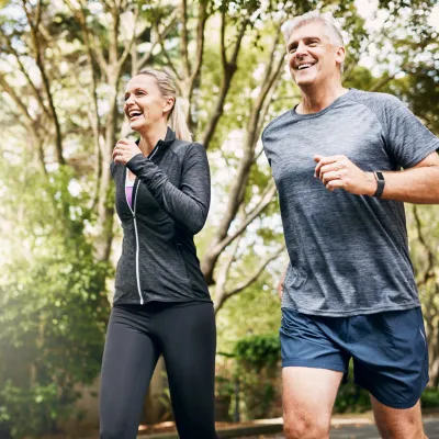 A couple runs outside together.