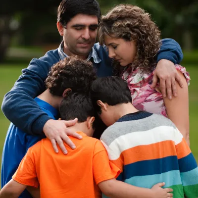 A family hugs and counts their blessings.