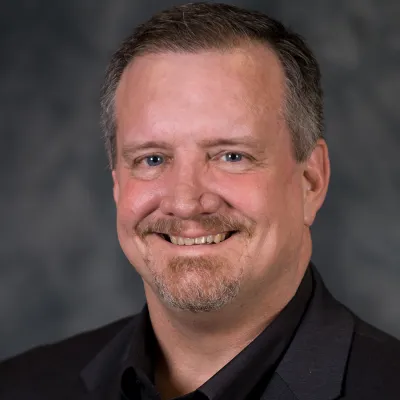 A Headshot of Author Roy Reid