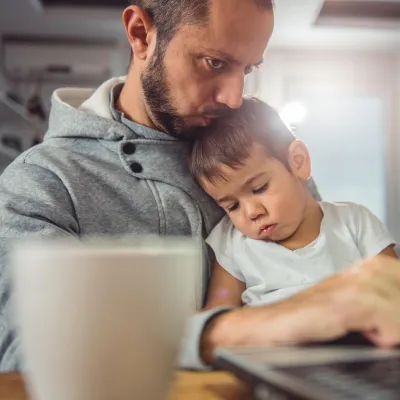 Father and son on the computer together.
