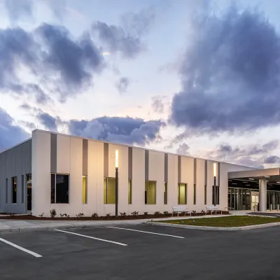 Exterior of AdventHealth Care Pavilion Heathbrook in the evening.