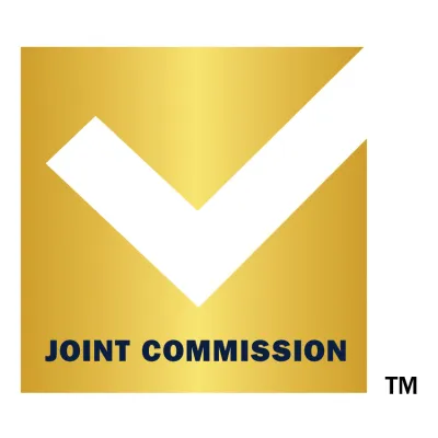 The Joint Commission gold background with white check badge.