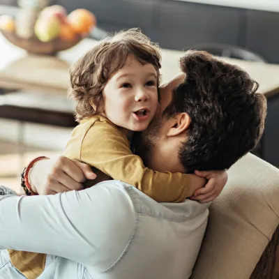 Child hugging her father