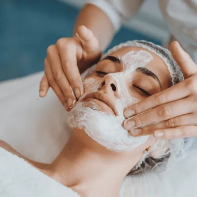 A woman receiving a facial.