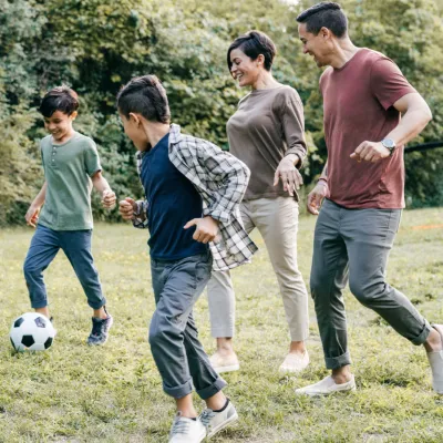 Family playing soccer together at home.