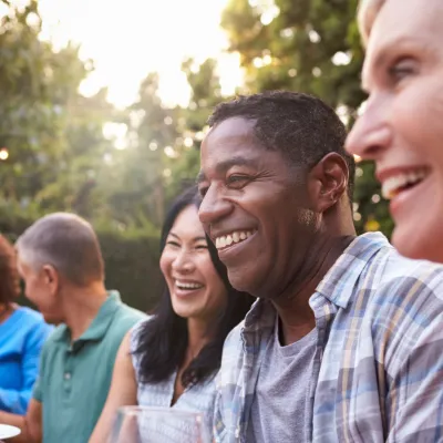 Friends sitting outdoors at a table during a dinner party.