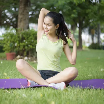 woman doing yoga in a park