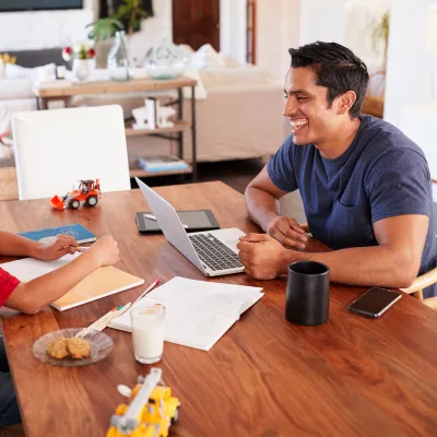 Dad working from home with his son