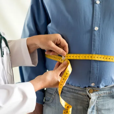 A man visits his doctor for a check up after bariatric surgery.