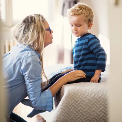 A mother comforts her young son.