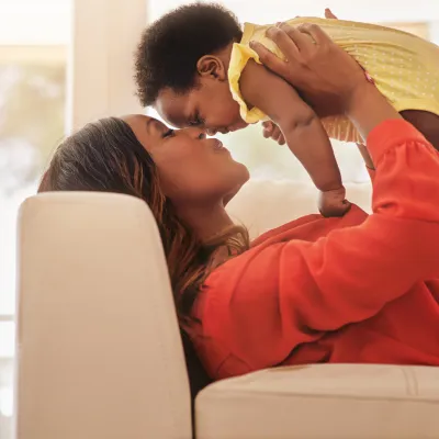 A mother kisses her baby.