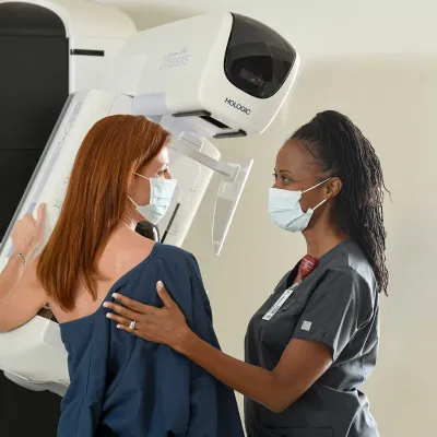 A woman being helped by her nurse for an x-ray