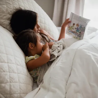Older child reading to younger child