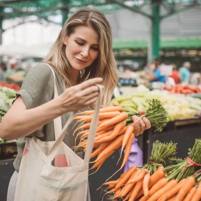 A woman shops for produce at the grocery store